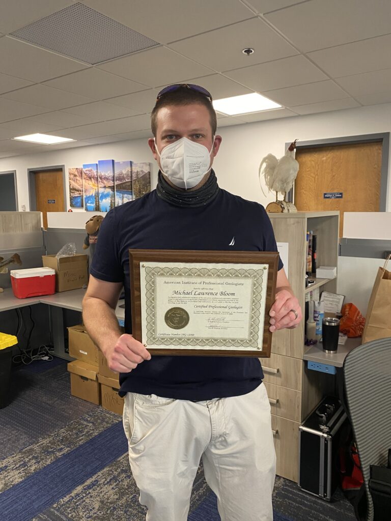 Michael L. Bloom holding a certificate