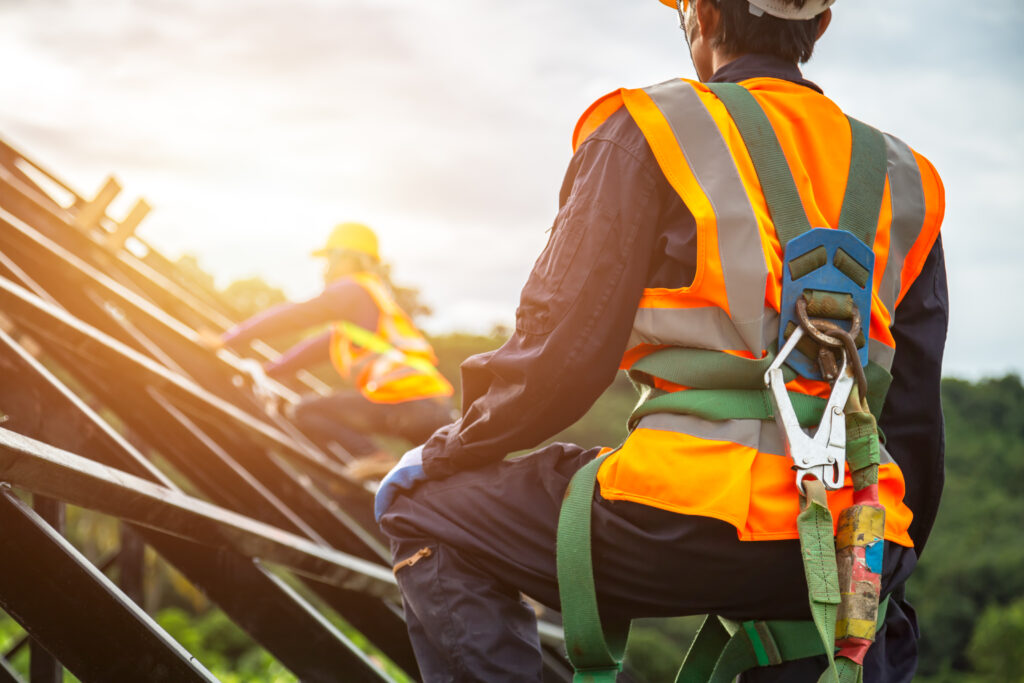 Construction worker sating at a roof