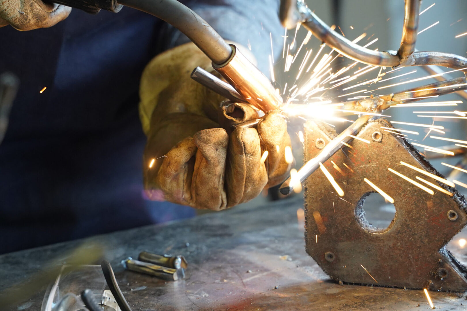 A welder is working on a piece of metal.