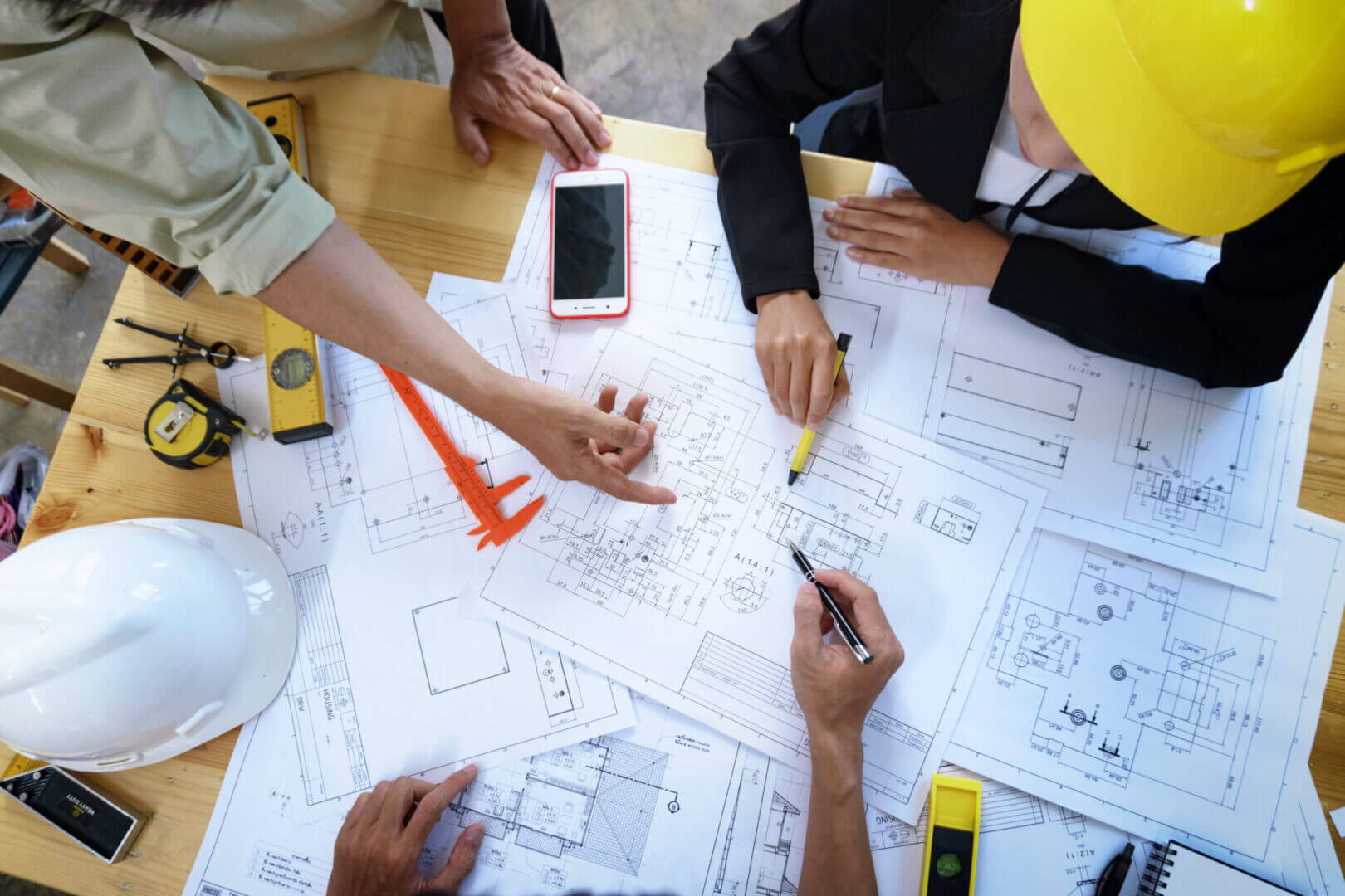 A group of people working on blueprints.