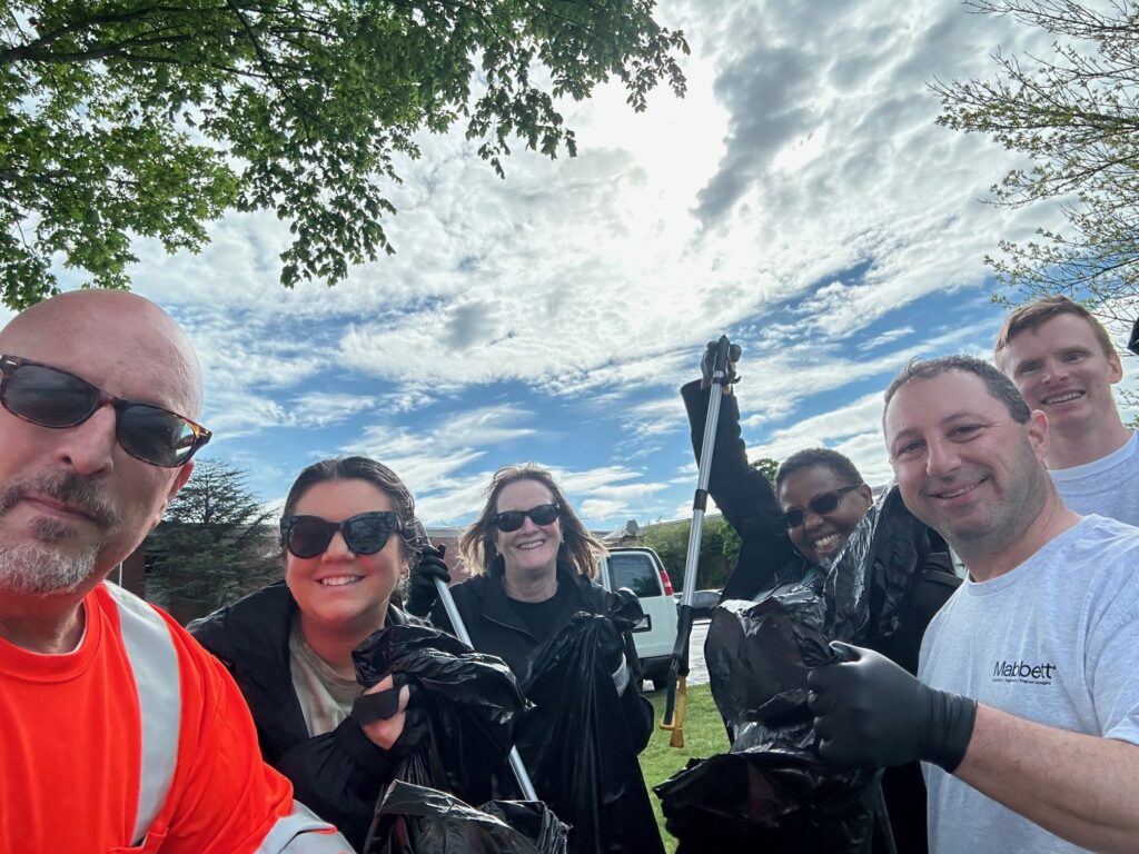 six people are posing for a group selfie