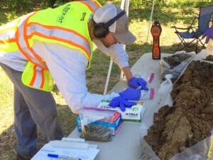 Environmental worker testing soil samples.
